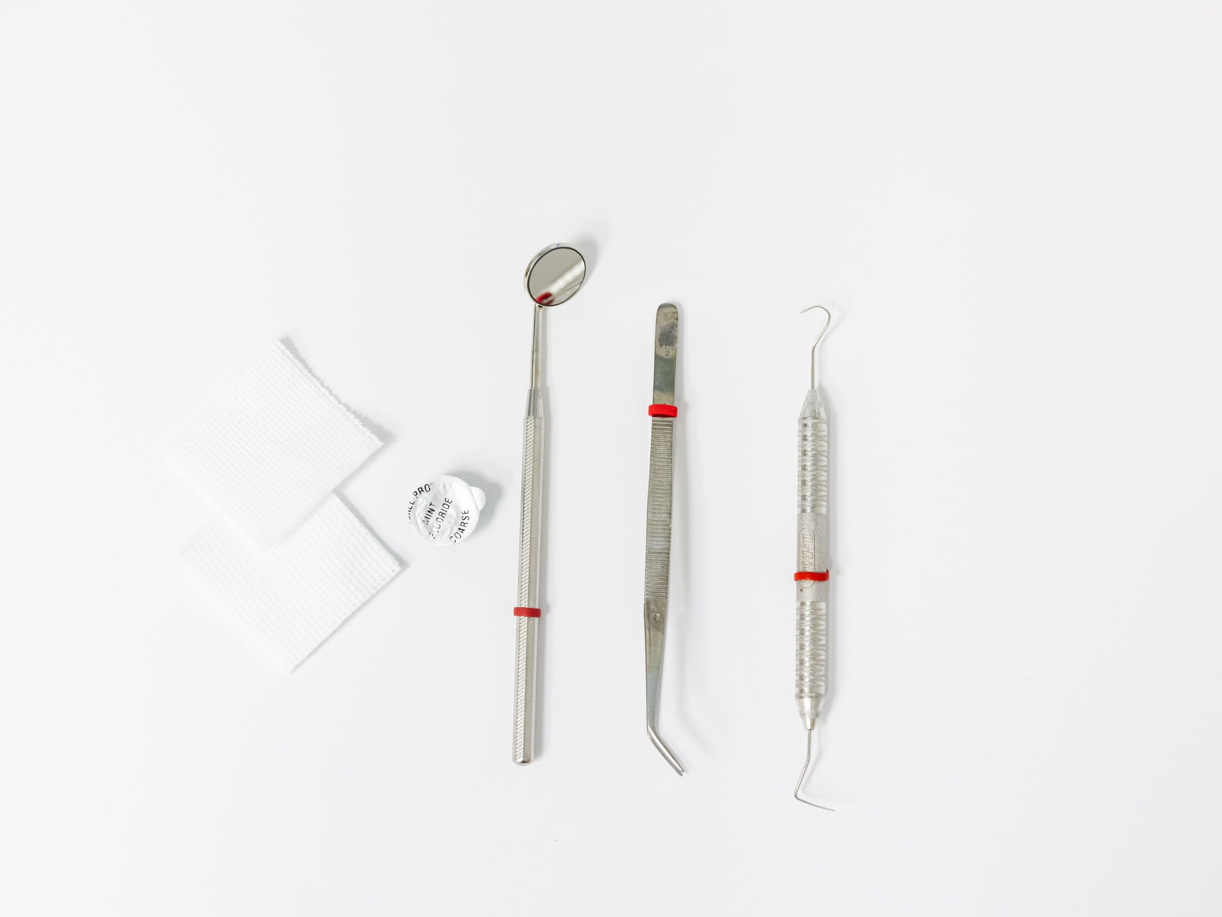 Mirror, tweezers and probe on a white background